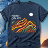 Navy t-shirt with "higher GROUND" text and colorful mountain landscape.