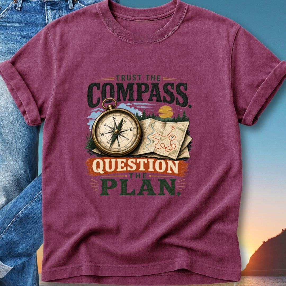 Burgundy t-shirt with "Trust the Compass, Question the Plan" and compass graphic.