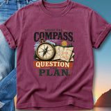 Burgundy t-shirt with "Trust the Compass, Question the Plan" and compass graphic.