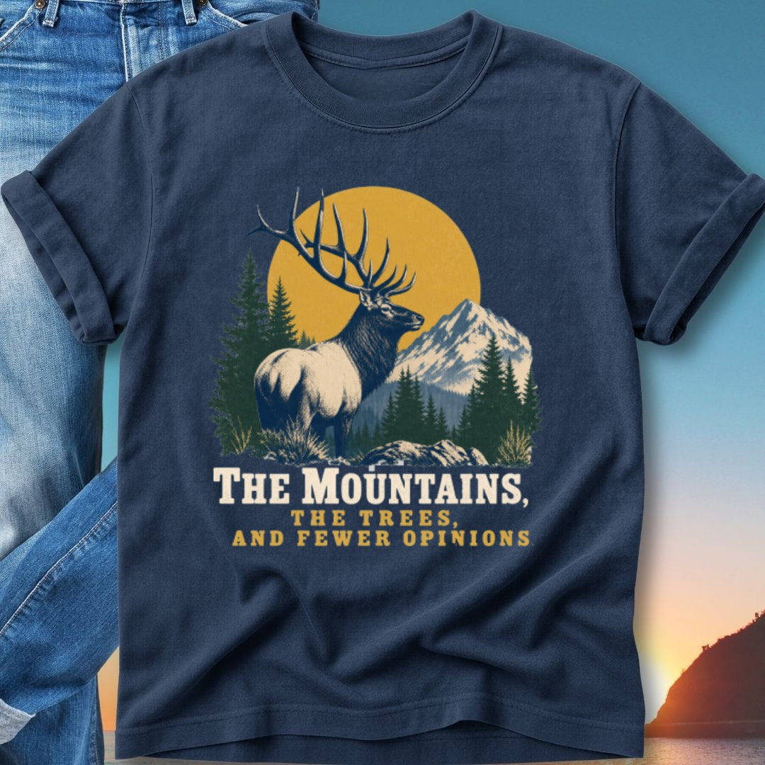 Navy t-shirt with elk, mountains, and text "The Mountains, The Trees, And Fewer Opinions".