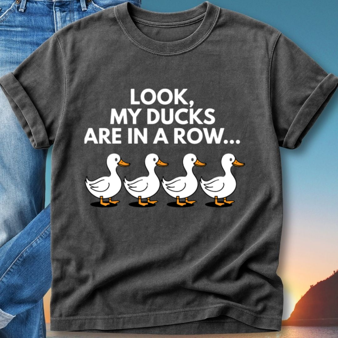 T-shirt with text "Look, my ducks are in a row..." and four cartoon ducks.