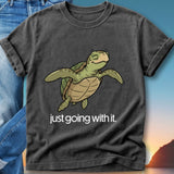 Black t-shirt with a cartoon sea turtle and the text "just going with it."