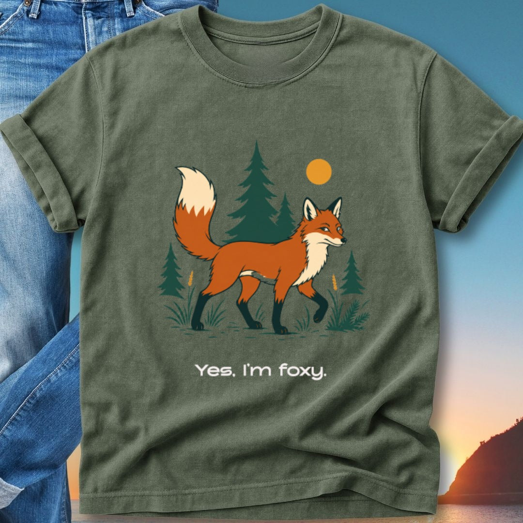 Green t-shirt with a walking fox and pine trees.