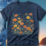 Navy t-shirt with a watercolor floral design of orange and yellow marigolds.