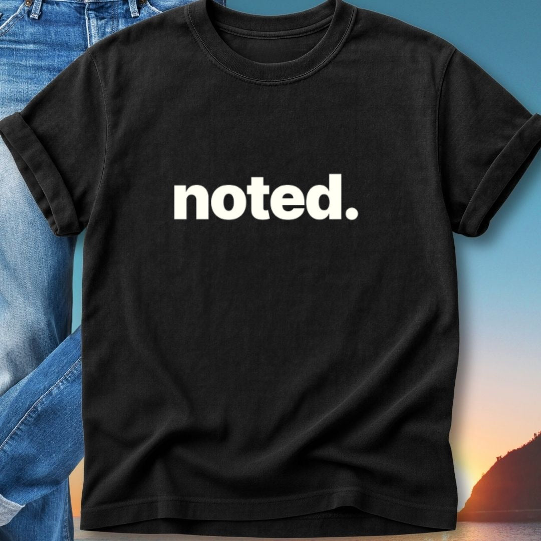 Black t-shirt with "noted." in white text, displayed with denim.
