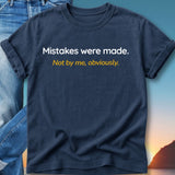 Navy t-shirt with white text "Mistakes were made." and yellow text "Not by me, obviously.".