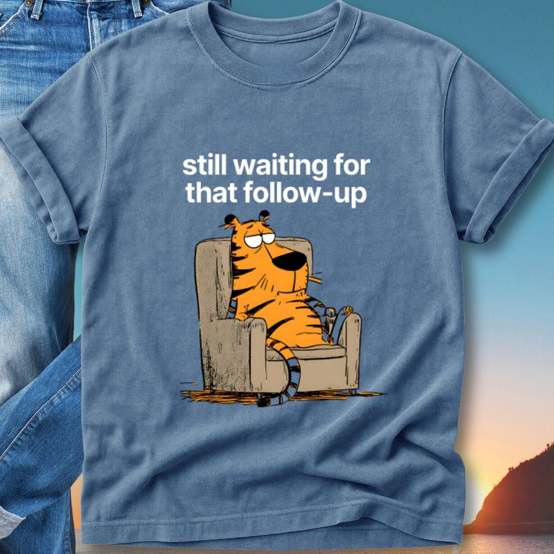 T-shirt with cartoon tiger sitting in armchair, "still waiting for that follow-up" text.