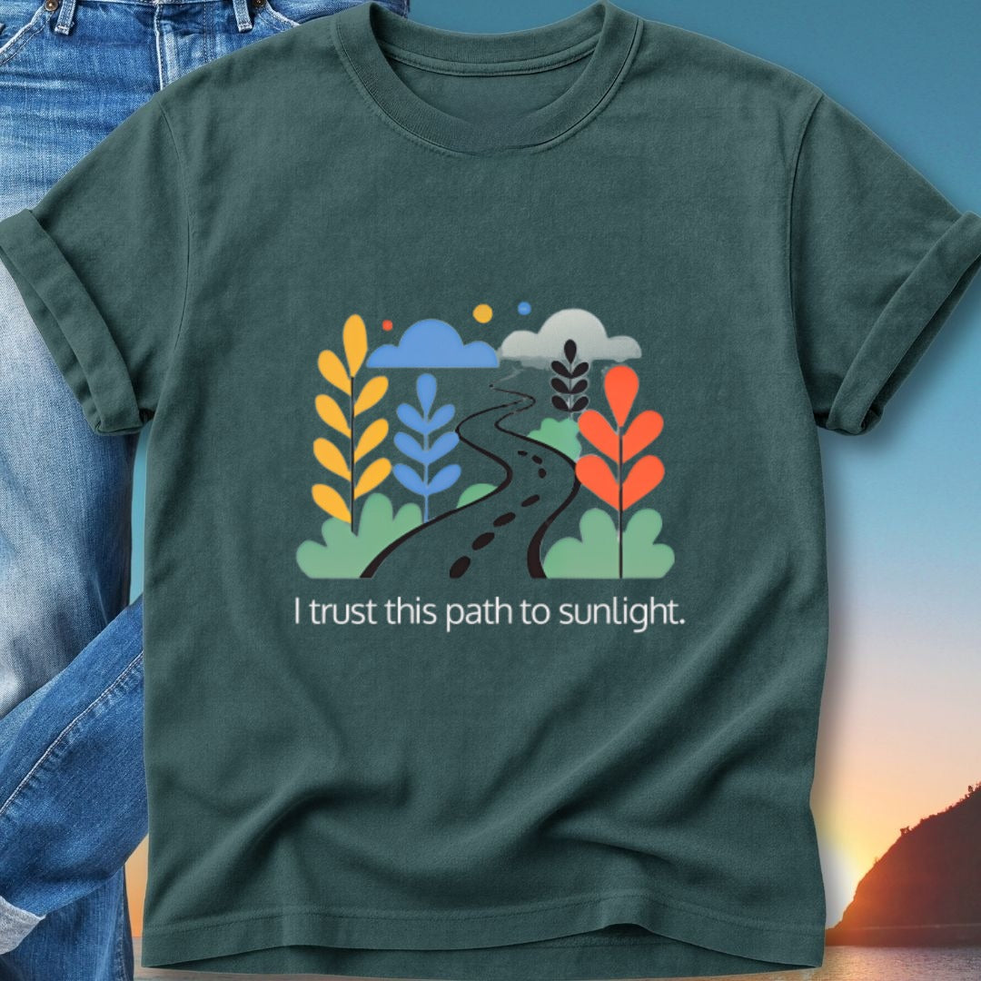Dark green t-shirt with winding path, plants, and text "I trust this path to sunlight."