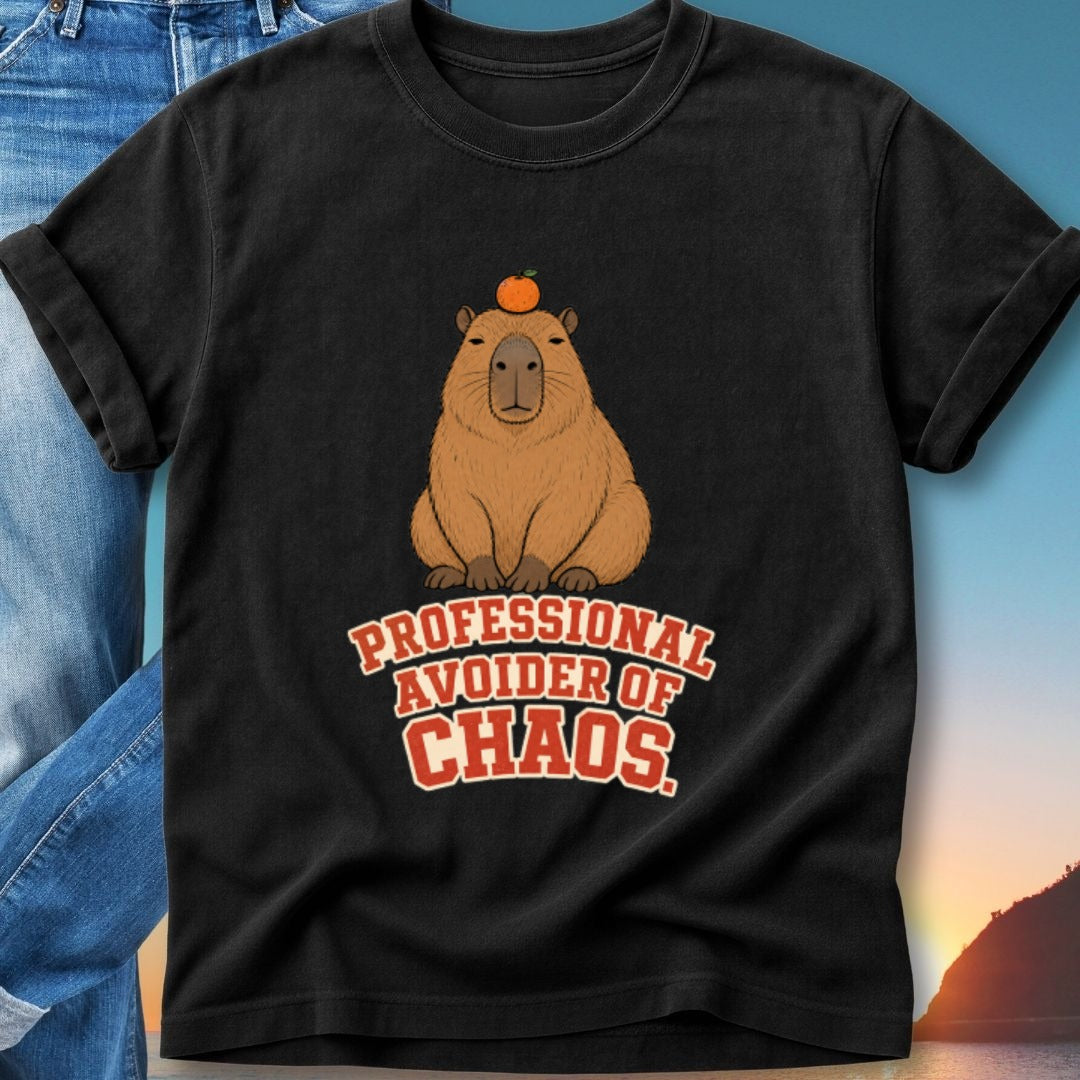 Black t-shirt with capybara wearing an orange on its head and "PROFESSIONAL AVOIDER OF CHAOS" text.