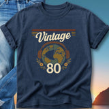 Navy t-shirt with "Vintage 80" graphic of globe wearing headphones.