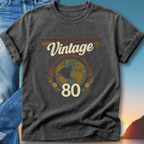 Vintage 80s t-shirt with headphones around a globe and floral accents.