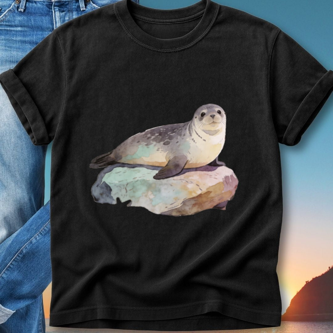 Black t-shirt featuring a watercolor painting of a seal resting on a rock.