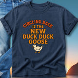 Navy t-shirt with "Circling Back Is The New Duck Duck Goose" and a goose graphic.