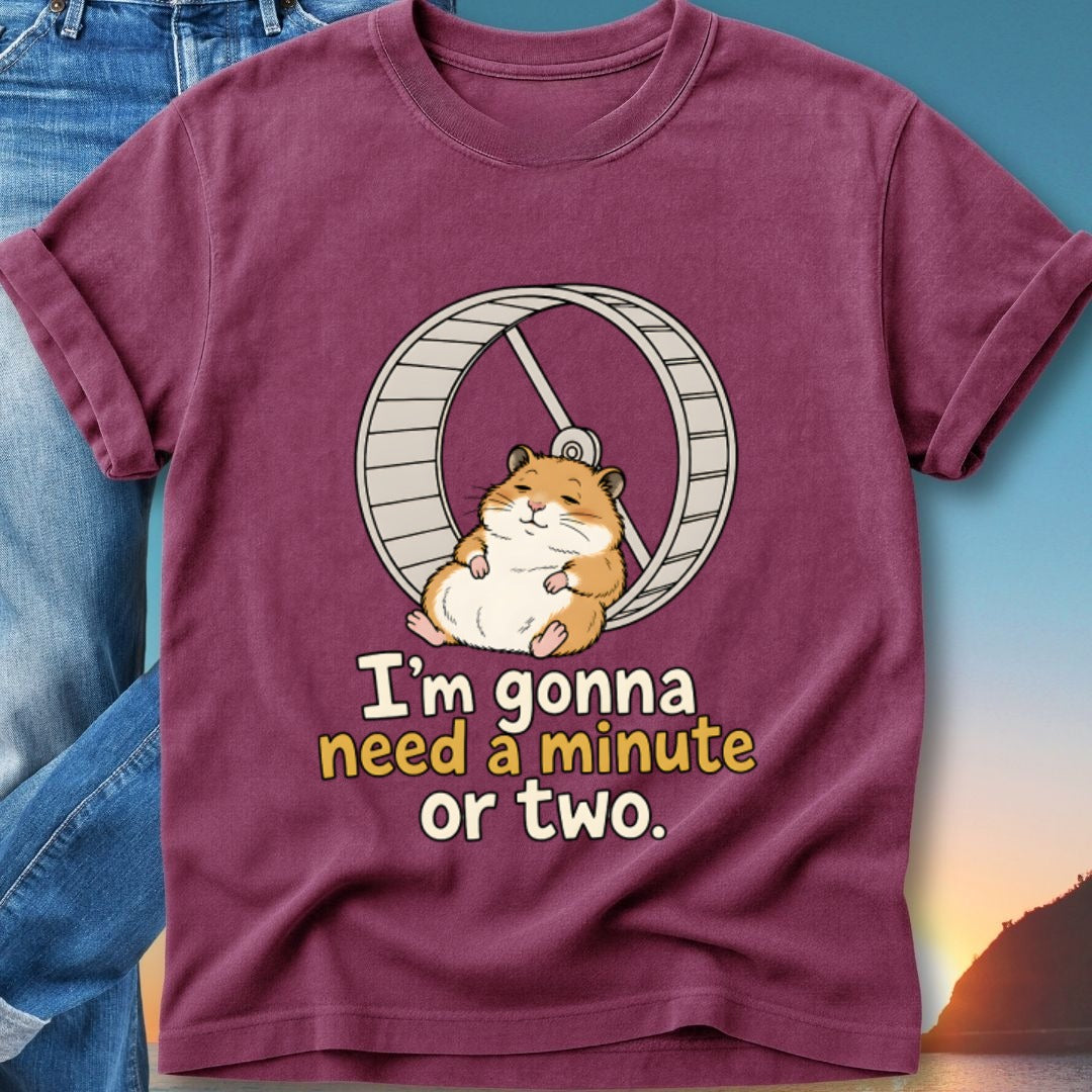 Maroon t-shirt with a cartoon hamster on a wheel and text.