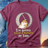 Maroon t-shirt with a cartoon hamster on a wheel and text.