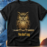 Black t-shirt with a golden owl wearing glasses, perched on a branch.