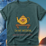 Teal t-shirt with yellow teapot illustration and text.