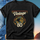 Black t-shirt with "Vintage 80" text and a globe graphic.
