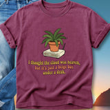 Maroon t-shirt with a drawing of a potted plant on a beige router and text.