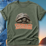 Olive green t-shirt featuring a tortoise and text about seeking asylum in the guest bedroom.