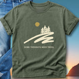 Green t-shirt with graphic of trees, sun, and text "SOME THOUGHTS NEED TREES."