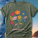 Green t-shirt with "plant person" text and a bouquet of colorful flowers.