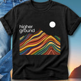Black t-shirt with "higher ground" and a colorful, abstract mountain landscape.