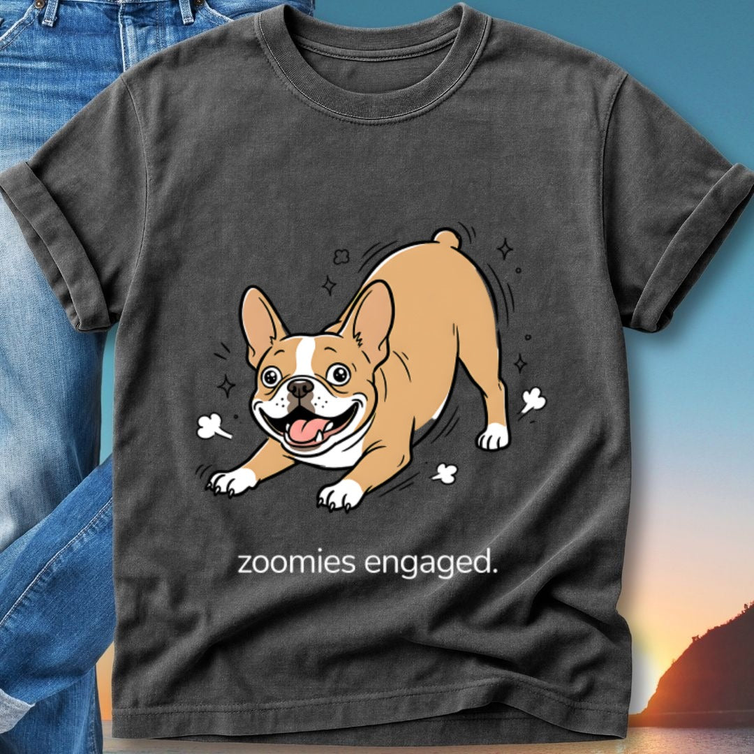French bulldog in a playful pose, wearing a t-shirt with "zoomies engaged" text.