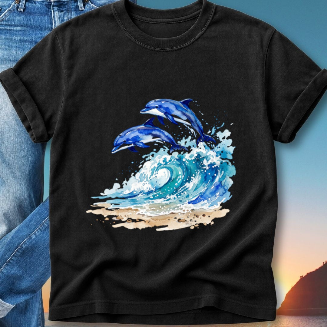 Two dolphins jump through a wave on a sandy beach.