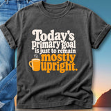 Dark t-shirt with "Today's primary goal is just to remain mostly upright" and an orange mug graphic.