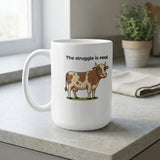 White mug with cartoon cow and text "The struggle is real."