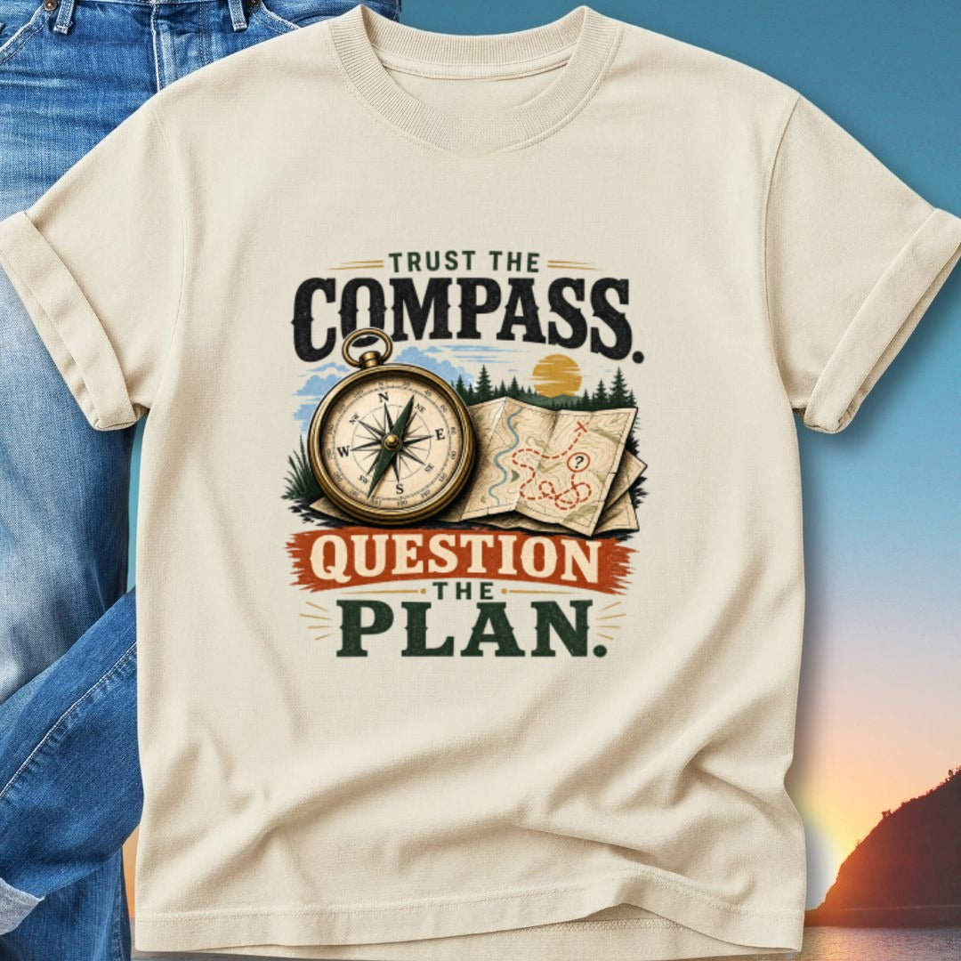 Cream t-shirt with "Trust the Compass, Question the Plan" text and compass graphic.