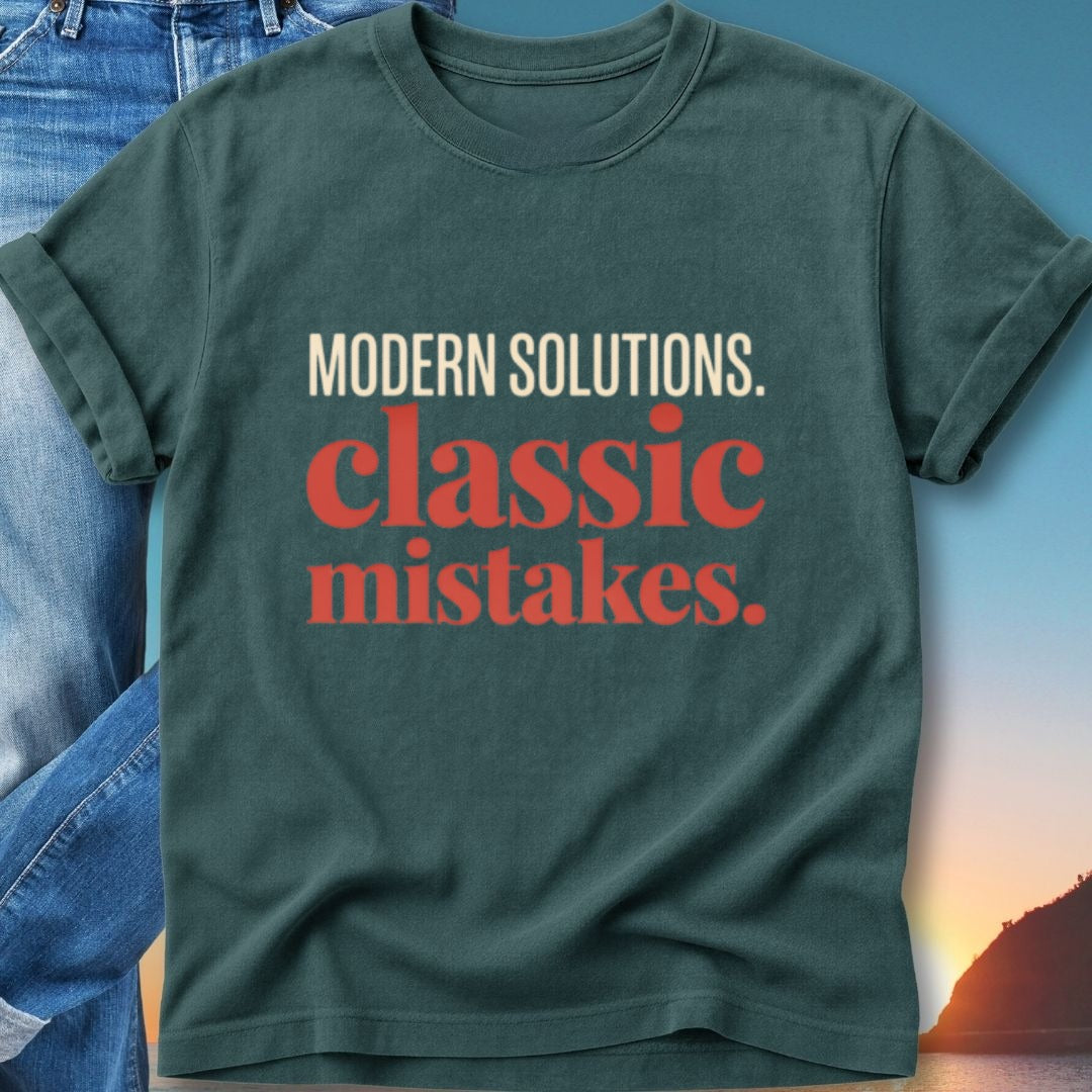 Dark green t-shirt with "MODERN SOLUTIONS. classic mistakes." text.