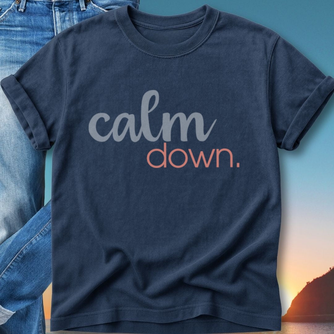 Navy t-shirt with "calm down." text, against a backdrop of jeans and a sunset.