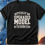 Black t-shirt with "Officially an upgraded model" and "The warranty is void but the wisdom is high" text.