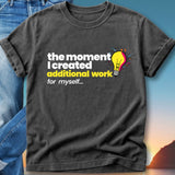 Dark t-shirt with text "the moment I created additional work for myself..." and a lightbulb graphic.