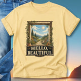 Yellow t-shirt with framed scenic landscape and "Hello, Beautiful" text.