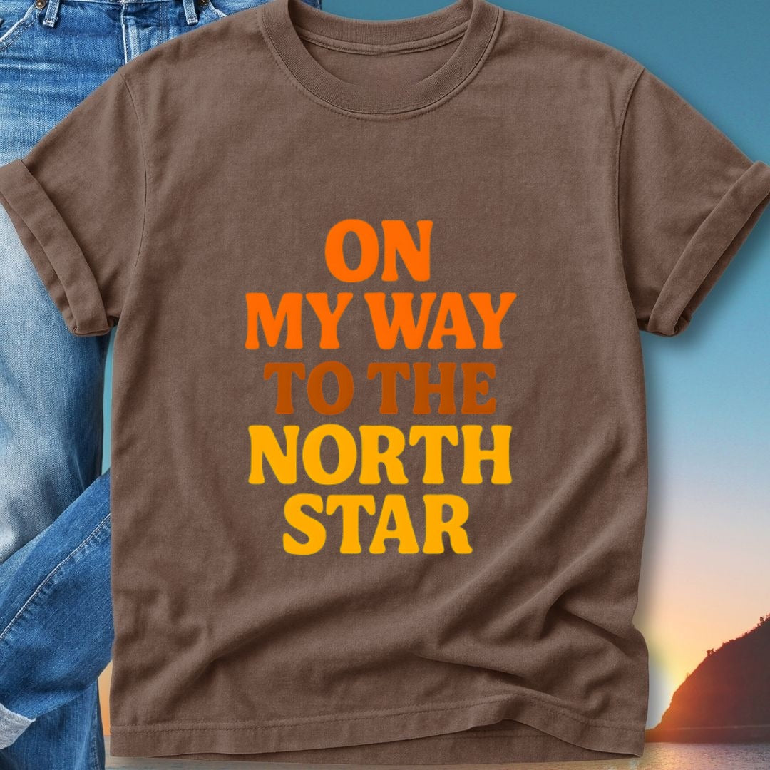 Brown t-shirt with "ON MY WAY TO THE NORTH STAR" text.