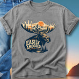 T-shirt graphic of a moose with mountains and forest, text reads "Easily Amoosed".