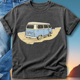 Blue camper van on a beach with sunset in the background.