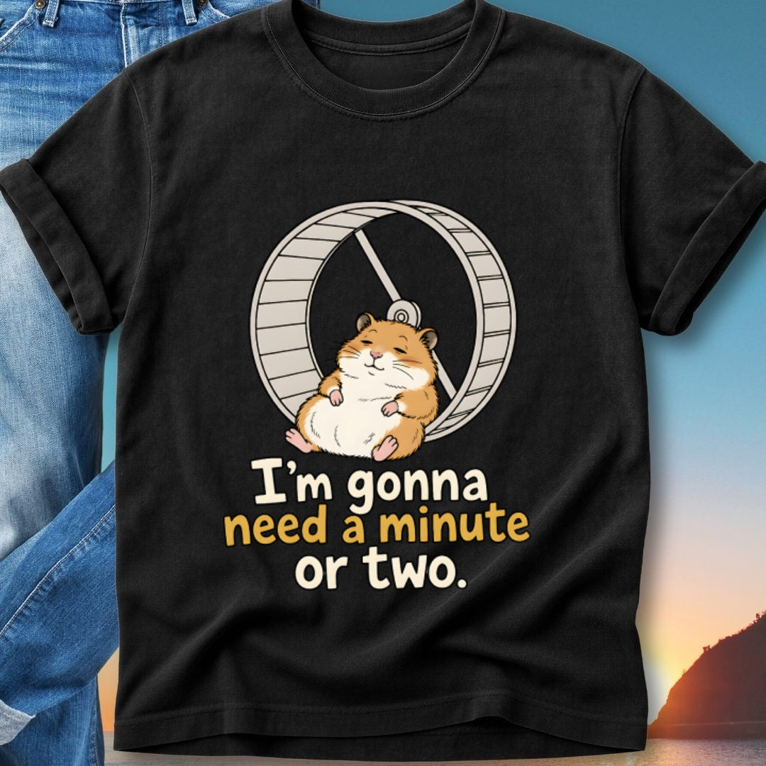Black t-shirt with cartoon hamster on a wheel and text "I'm gonna need a minute or two."