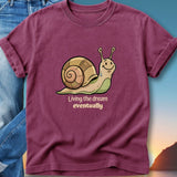 Maroon t-shirt with cartoon snail and text "Living the dream eventually".