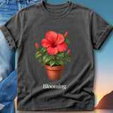 Dark grey t-shirt featuring a watercolor hibiscus flower in a pot and the word "Blooming".