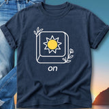 Navy t-shirt with sun icon and "on" text, set against a beach sunset.