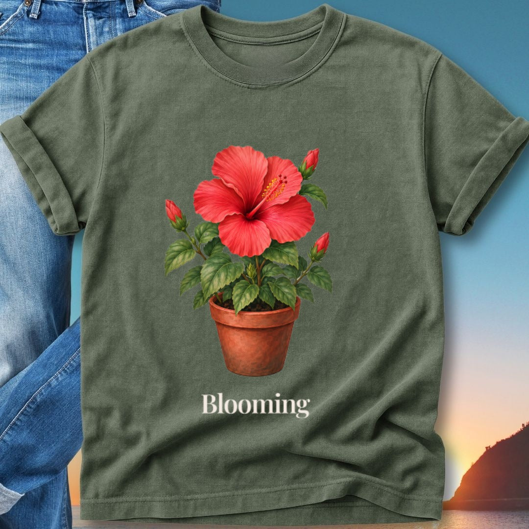 Green t-shirt with watercolor hibiscus flower in a pot and the word "Blooming".