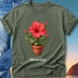 Green t-shirt with watercolor hibiscus flower in a pot and the word "Blooming".