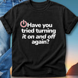 Black t-shirt with "Have you tried turning it on and off again?" text.