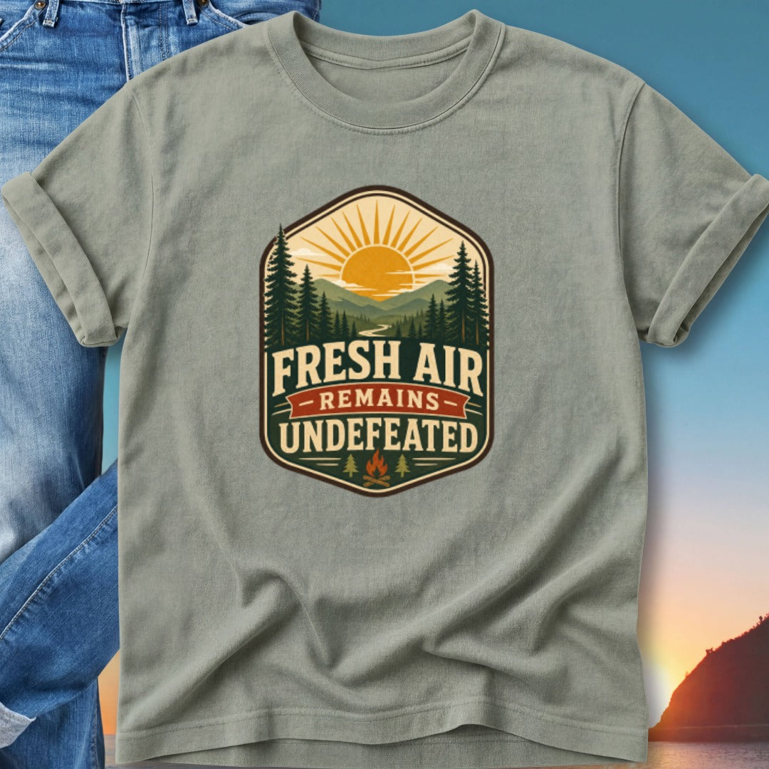 T-shirt with "Fresh Air Remains Undefeated" mountain sunset graphic.