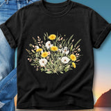Black t-shirt with a floral bouquet of dandelions and wildflowers.