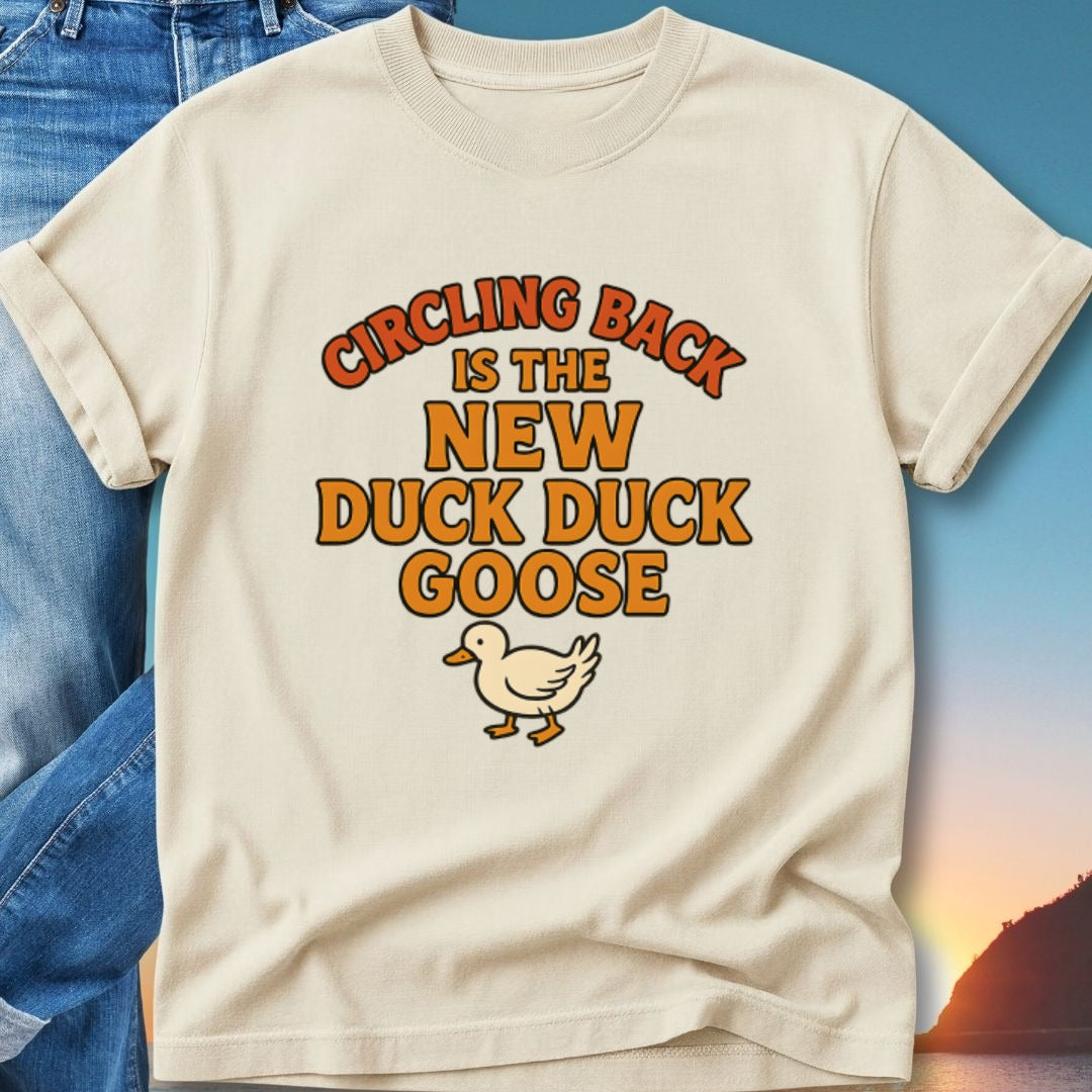Cream t-shirt with "Circling Back is the New Duck Duck Goose" text and duck graphic.